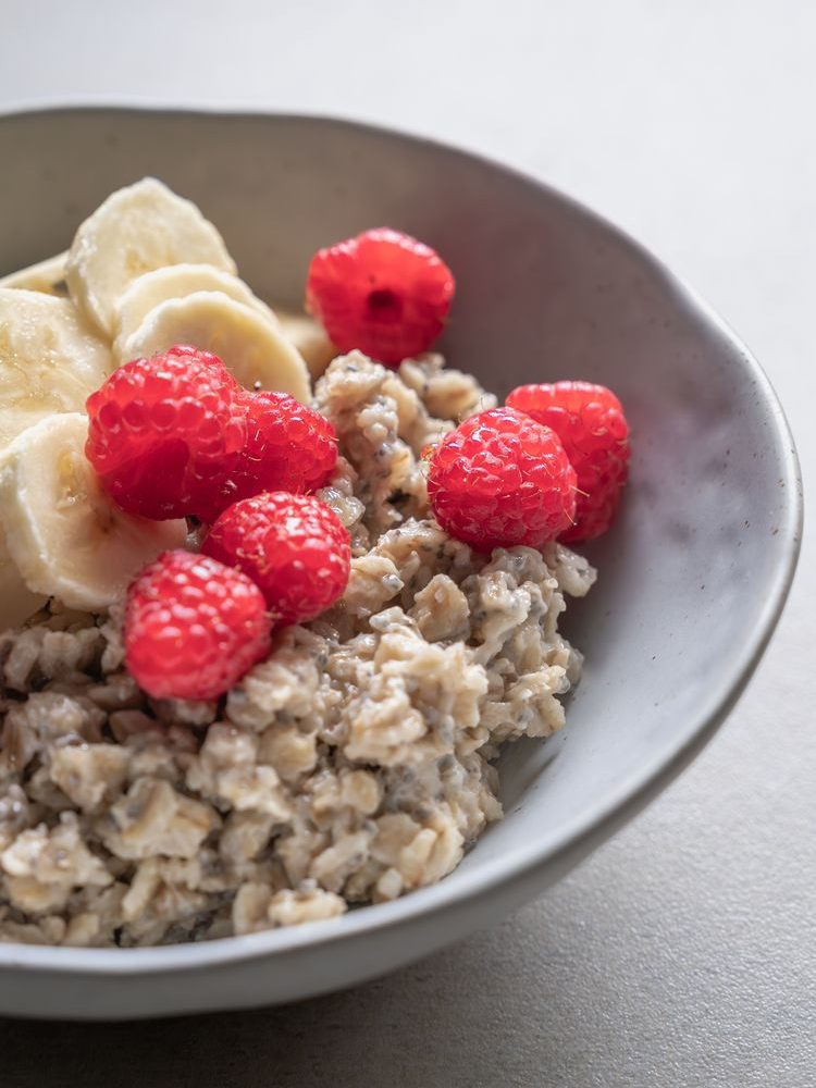delicious oatmeal with banana and raspberry topping